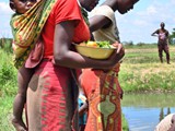 women_watching_fingerling_delivery_2